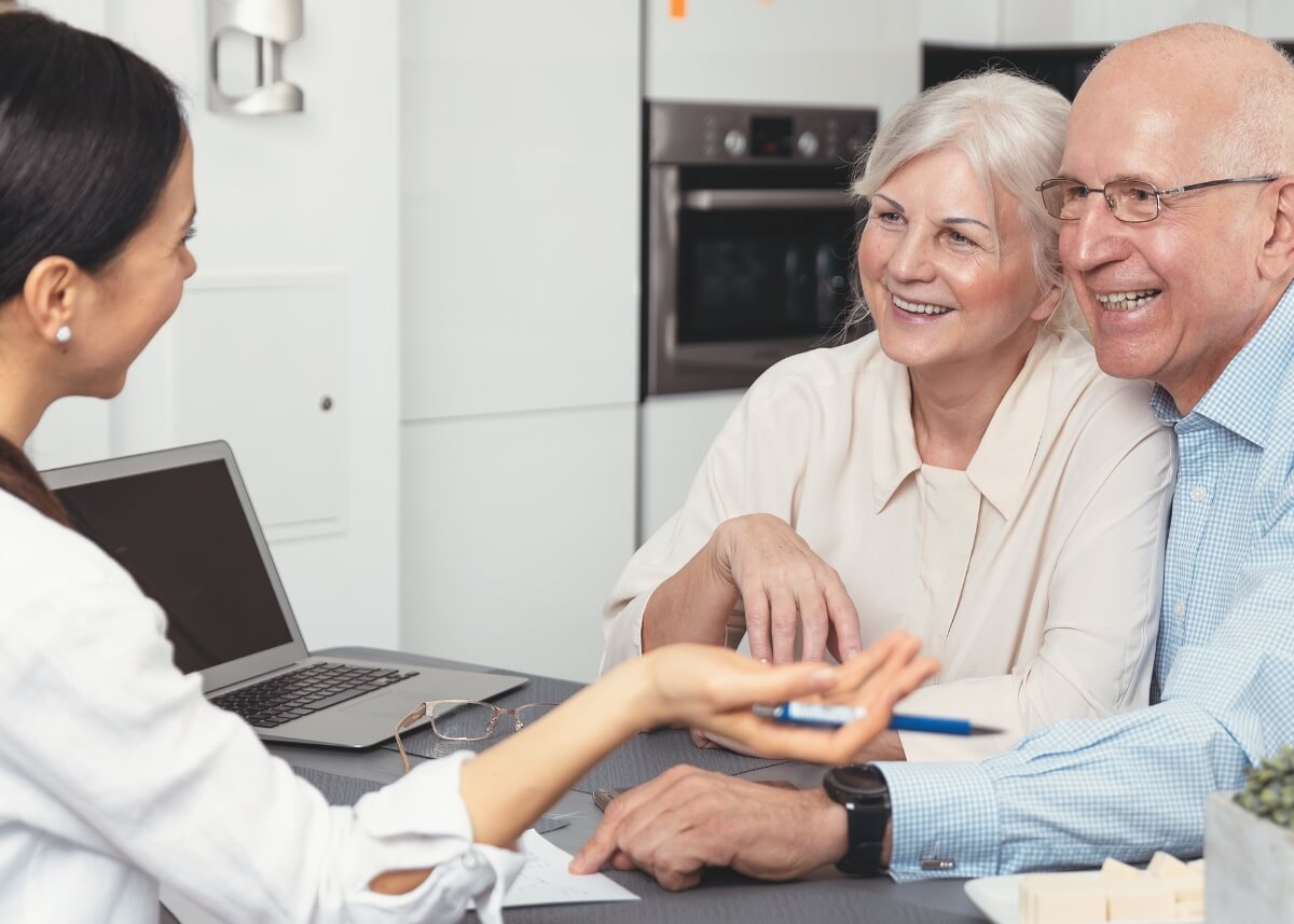 older couple with their lawyer at the kitchen table planning their estate