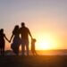 parents with their kids on the beach