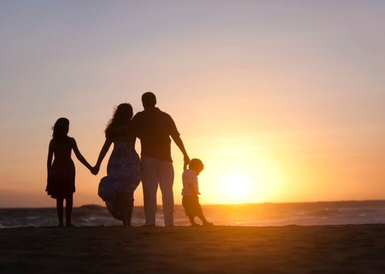 parents with their kids on the beach