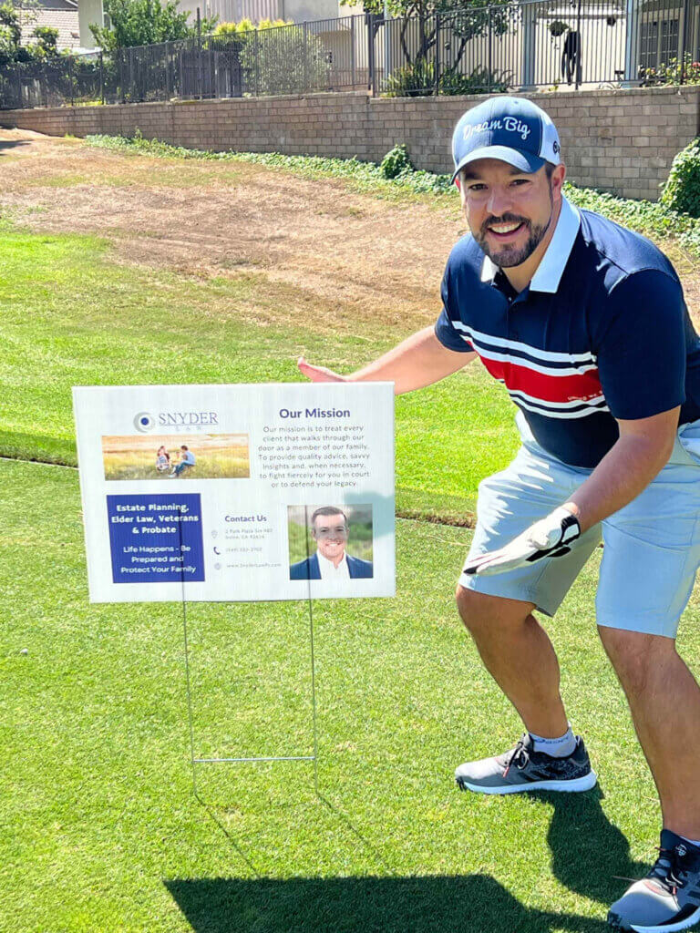 Snyder Law sign on the gold course supporting charities