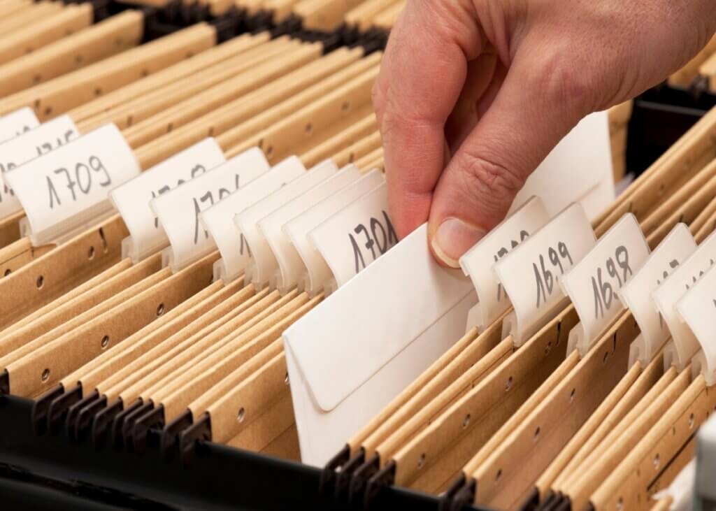 an image of documents in a file being sorted by year.