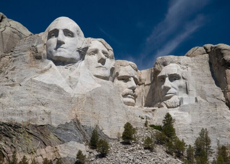 a picture of mt. rushmore showing all three presidents mentioned in the article that left their legacy behind for the rest of America.