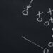 a chalkboard with a drawing of a football play out, mapping out their next play